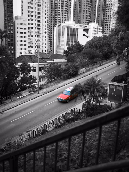 Hong Kong street with a red taxi